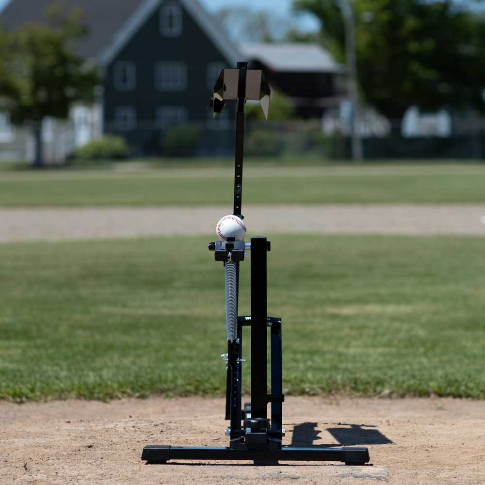 Louisville Slugger Black Flame UPM50 manual pitching machine set up on a baseball field